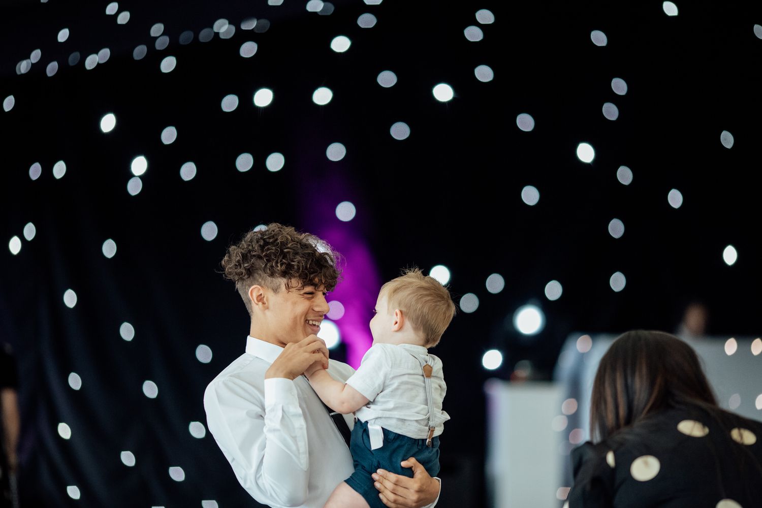 Wedding reception dance floor with string lights creating a magical atmosphere.