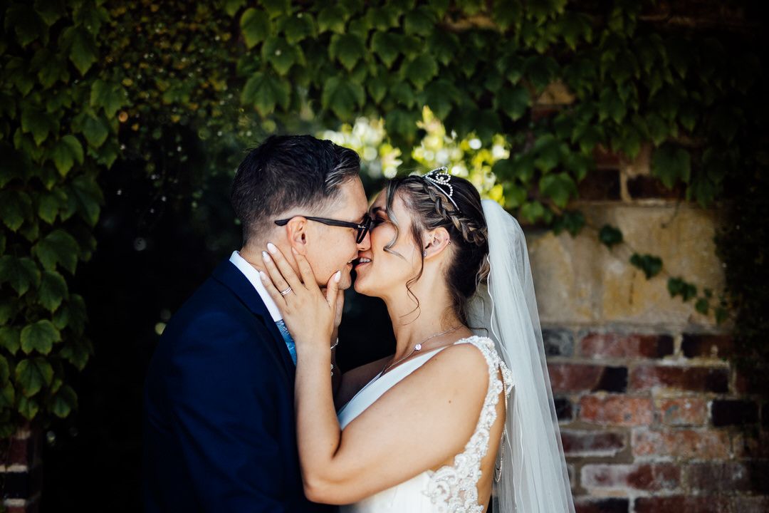 Intimate wedding moment captured in a lush garden setting.