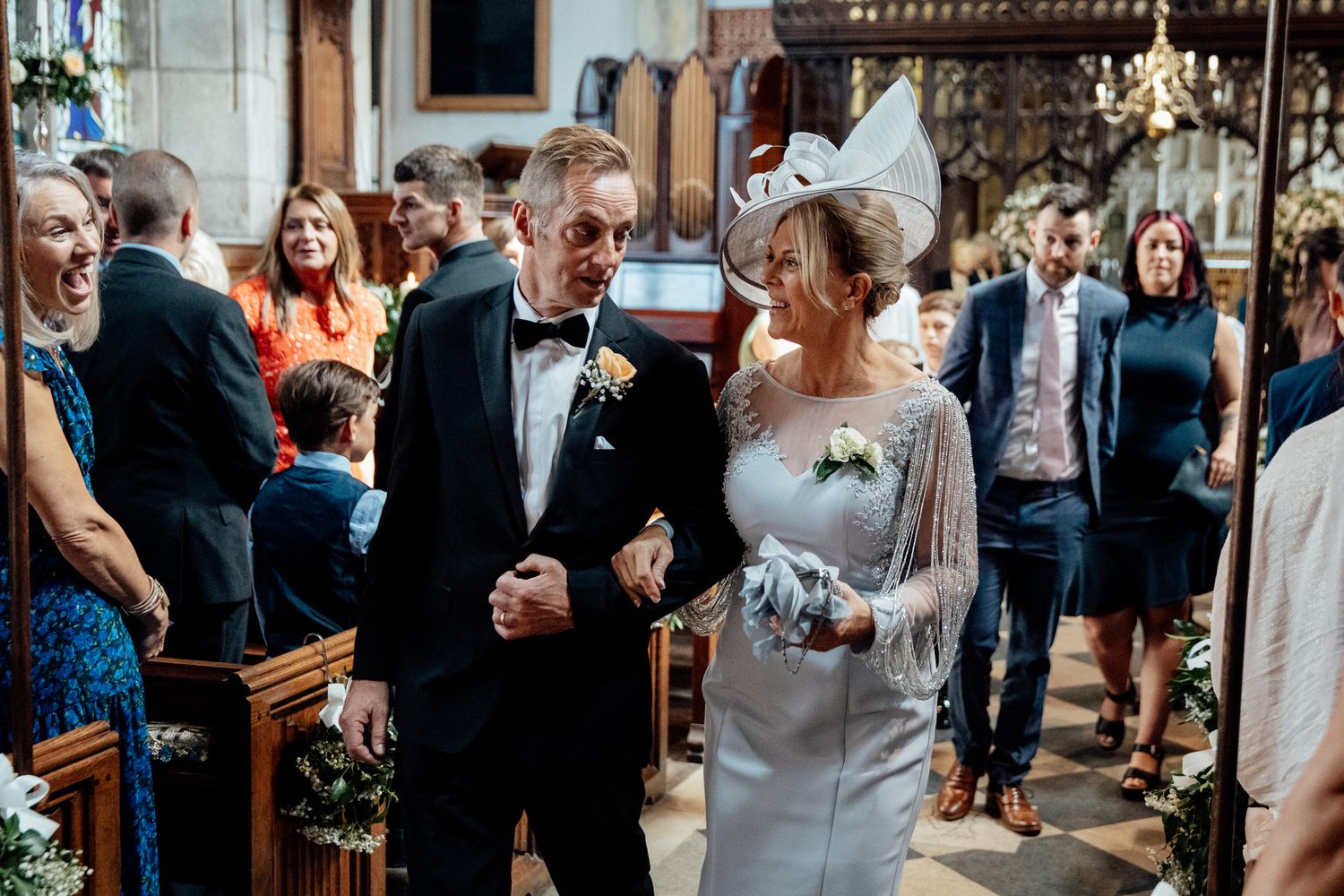 Wedding reception celebration with guests mingling in an elegant indoor venue.
