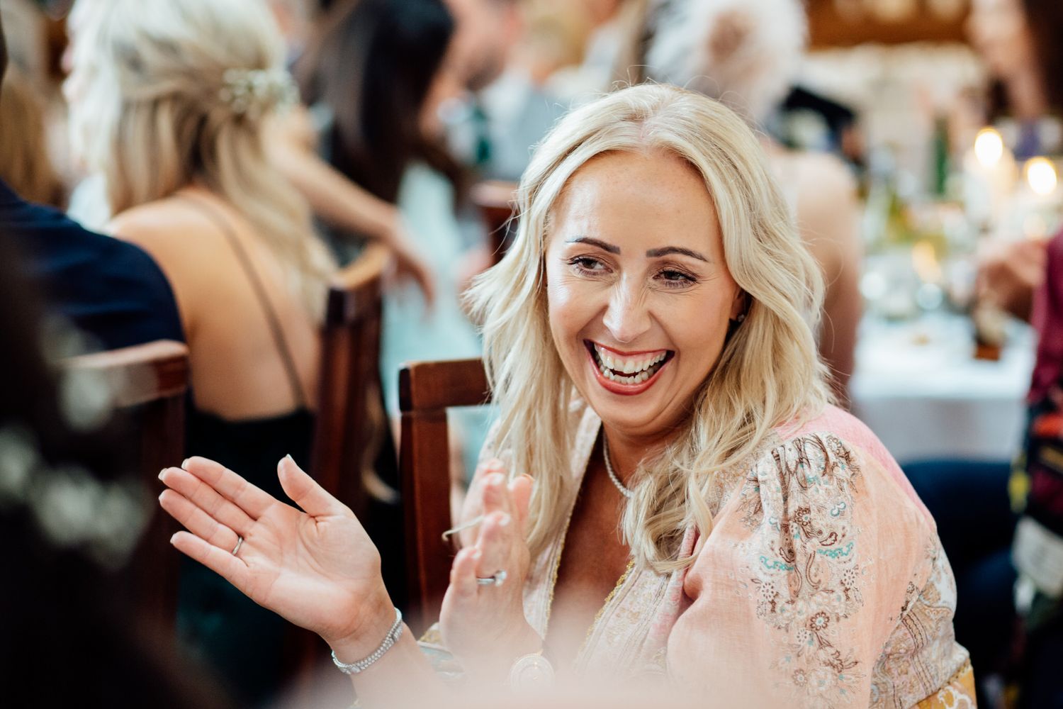 Wedding guests sharing joyful moments during reception dinner celebrations.