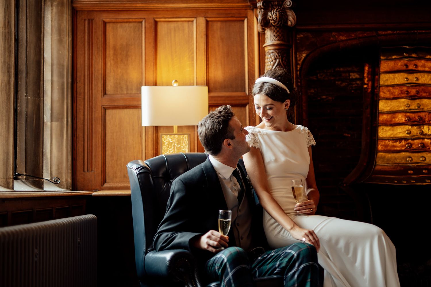 Intimate wedding scene in a dimly lit room with elegant furniture and warm ambiance.