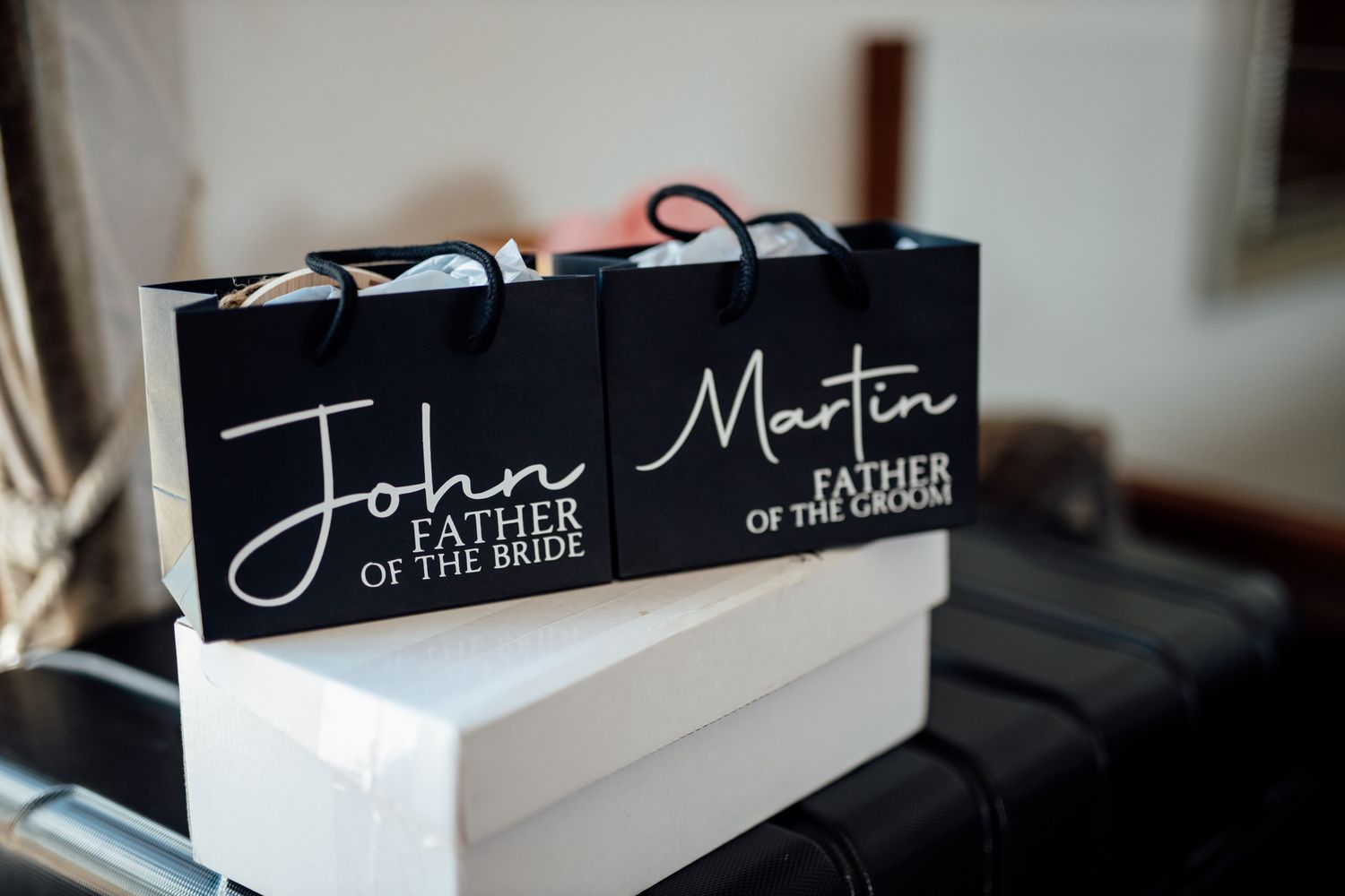 Black and white place cards for wedding party members displayed on table.