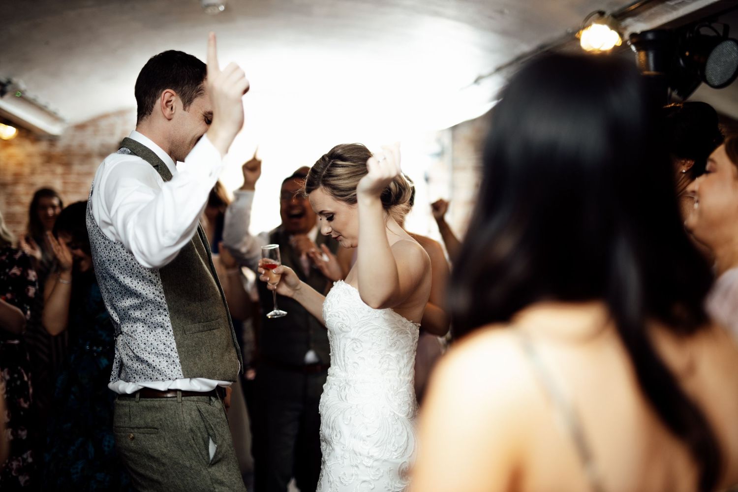 Wedding celebration candid moments captured during an indoor reception.