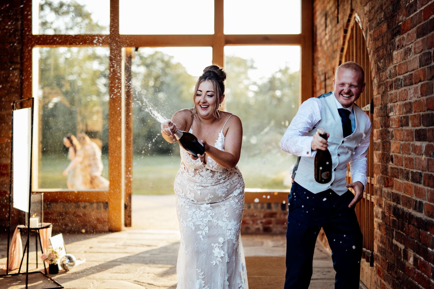 Rustic brick venue interior with large windows letting in natural light.