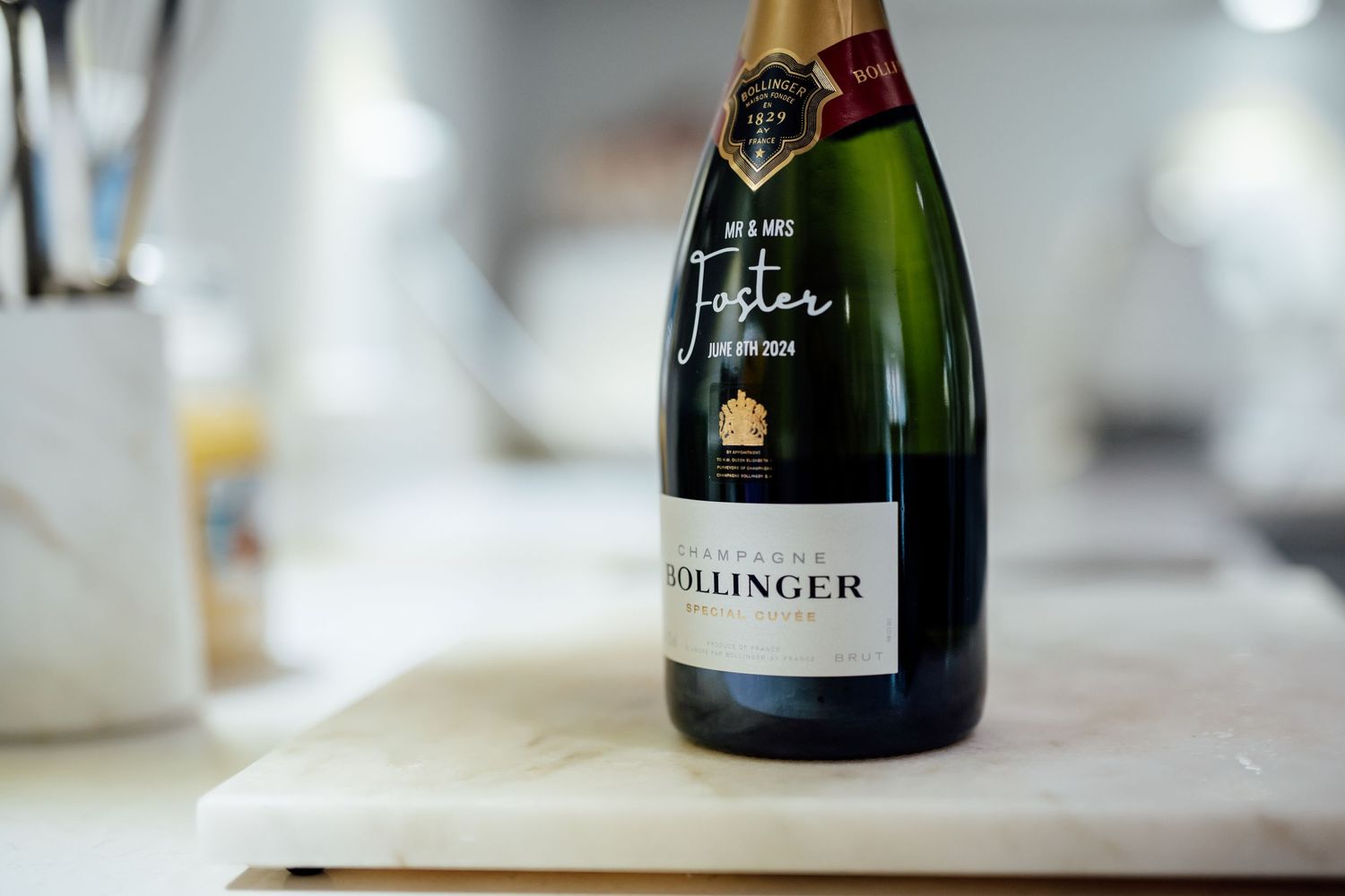Collection of champagne bottles displayed on a white surface.