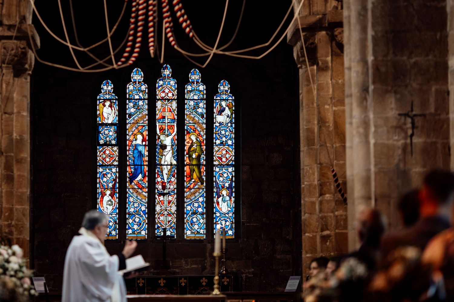 Gothic church interior with beautiful stained glass windows and stone architecture.