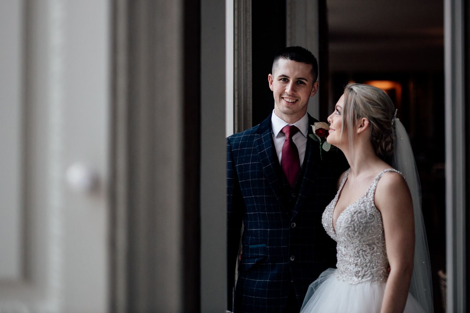 An intimate moment captured by a window in a classic interior setting.