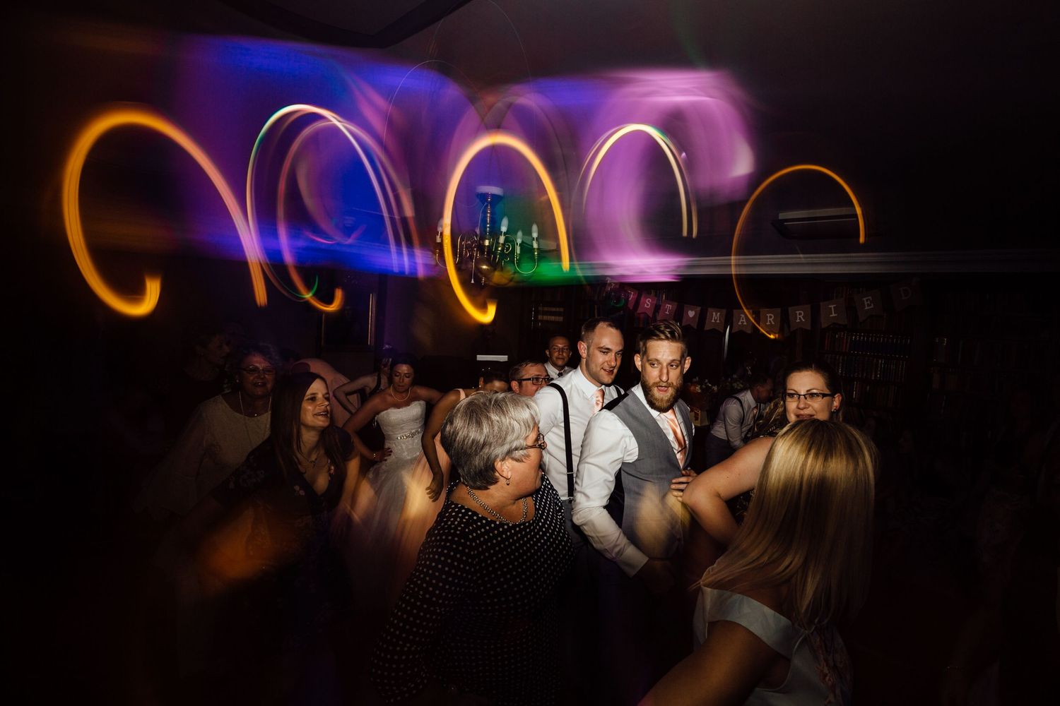 Dance party scene with orange and purple lighting effects creating an energetic atmosphere.