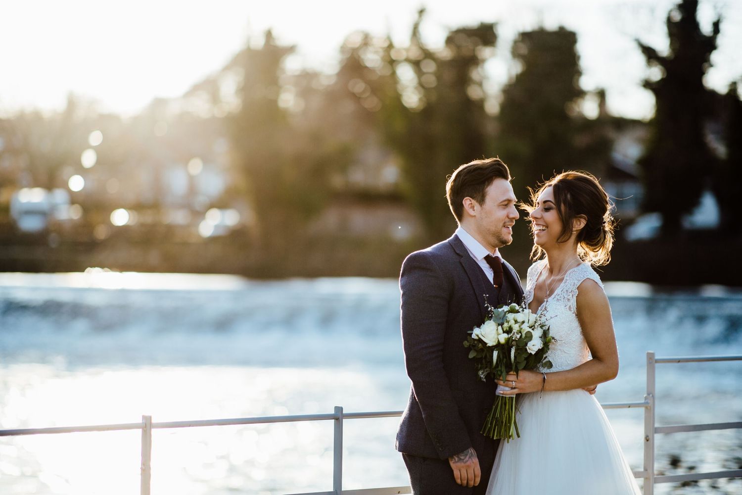Romantic waterfront wedding ceremony with scenic sunset backdrop.