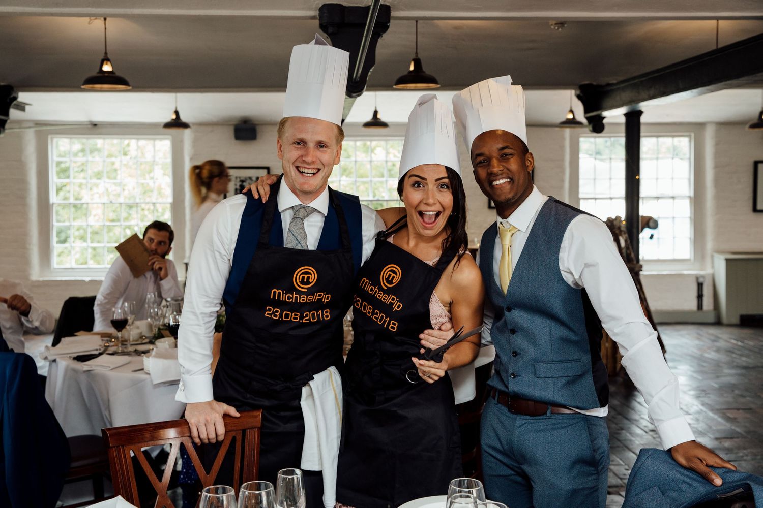 Wedding reception staff serving drinks in bright indoor venue.