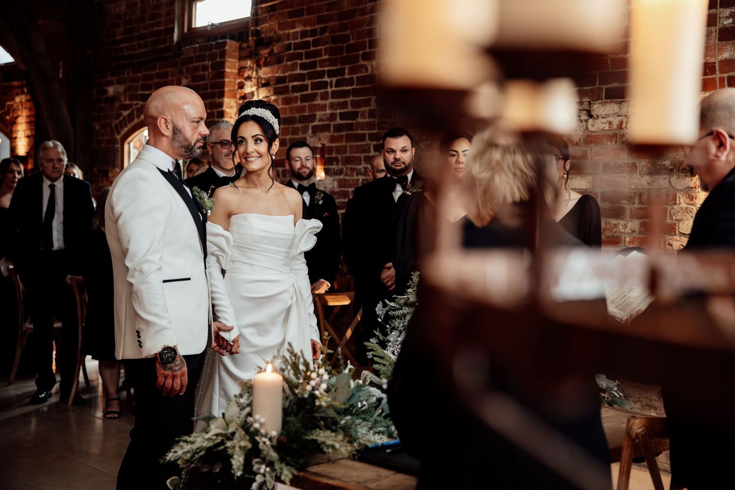 Wedding reception venue with exposed brick walls and ambient lighting.