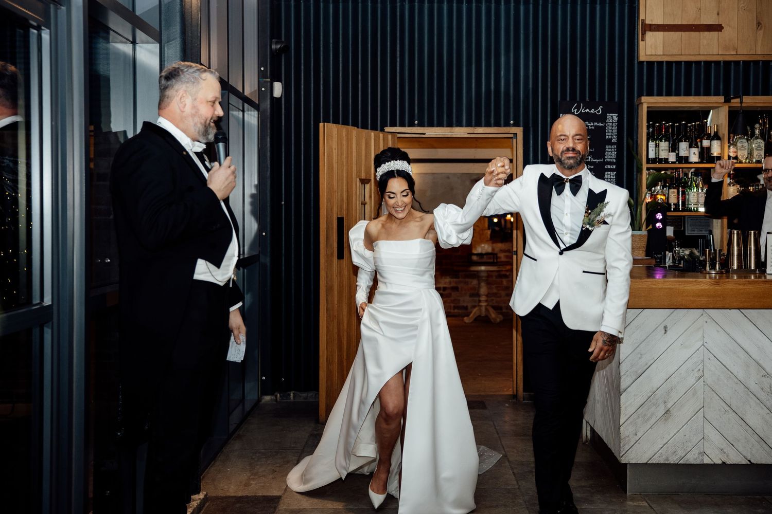 Elegant wedding reception dance floor filled with joyful guests celebrating and dancing in formal attire.