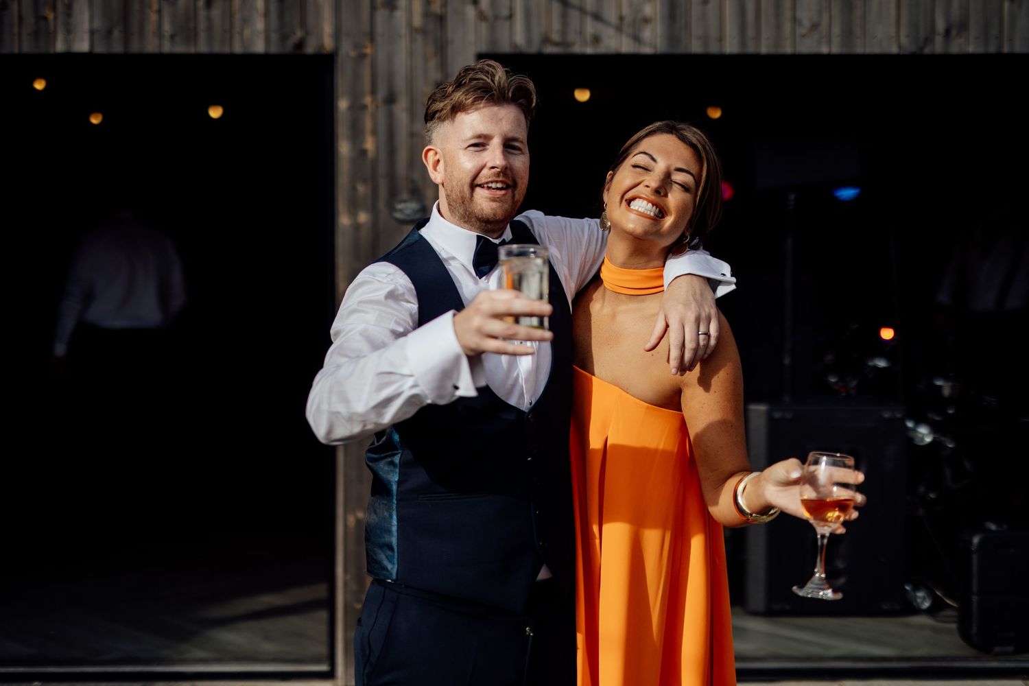 Evening wedding reception candid moments captured in warm lighting.