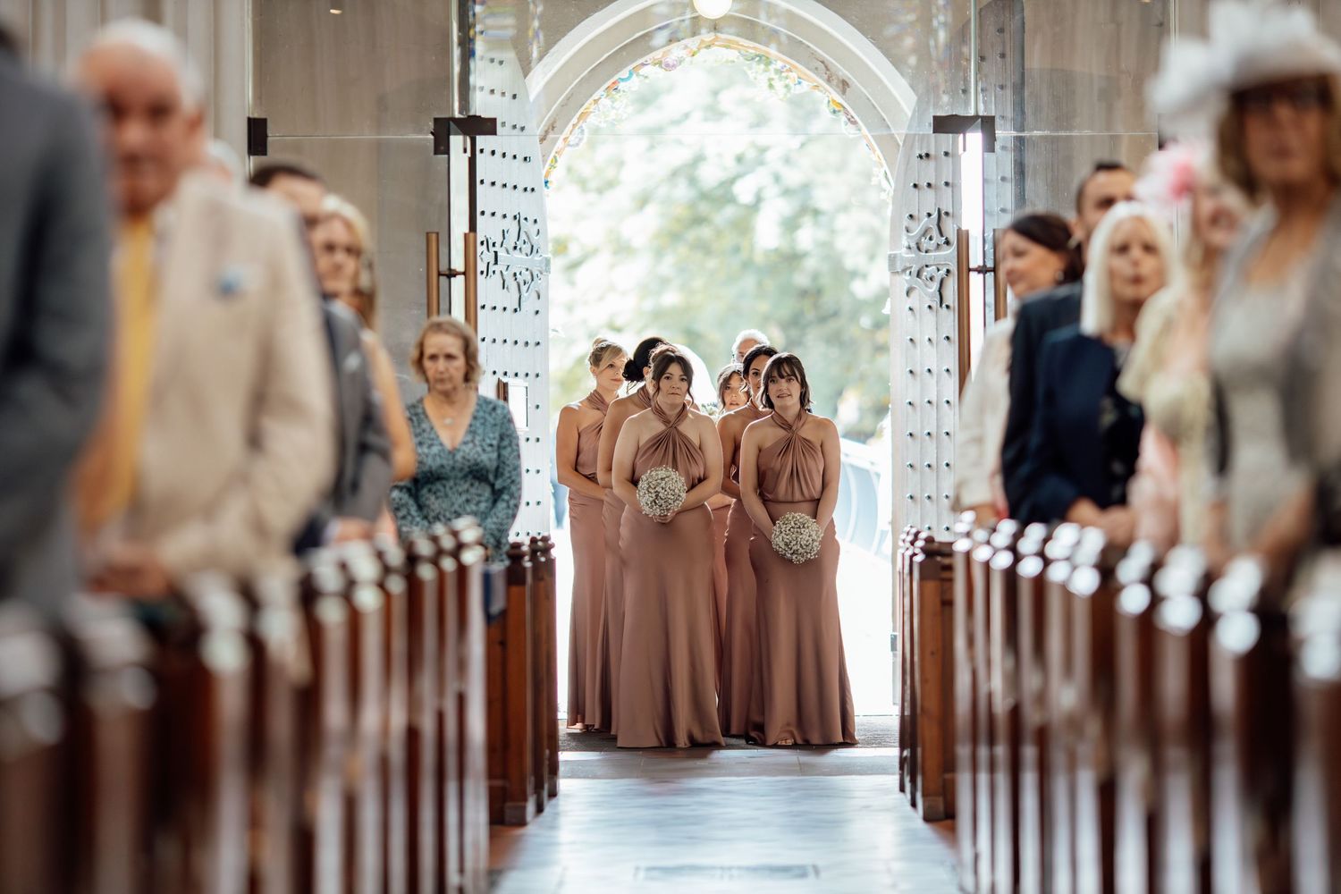 Church ceremony aisle view with soft focus and natural lighting.