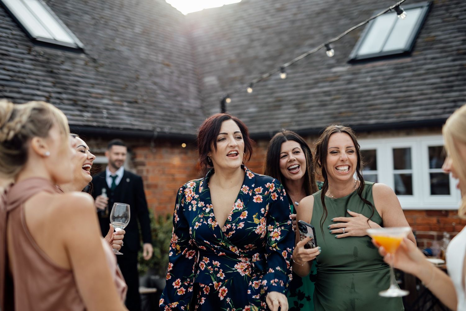 Wedding guests mingling outdoors during a casual reception celebration.