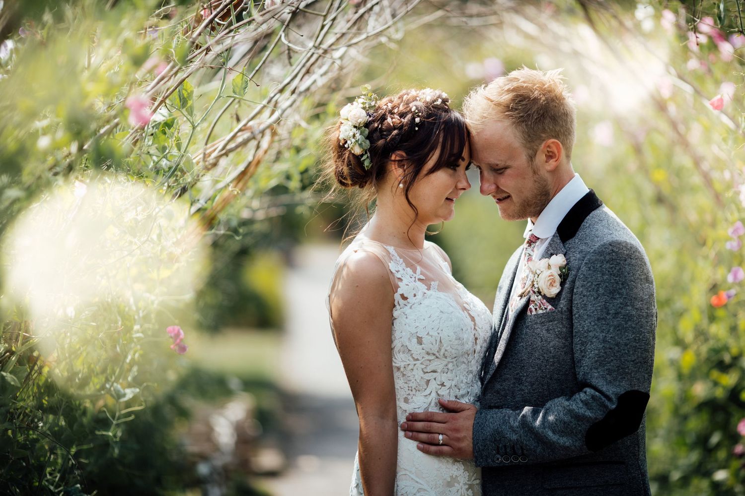 Romantic couple portraits in a garden setting with soft natural lighting.