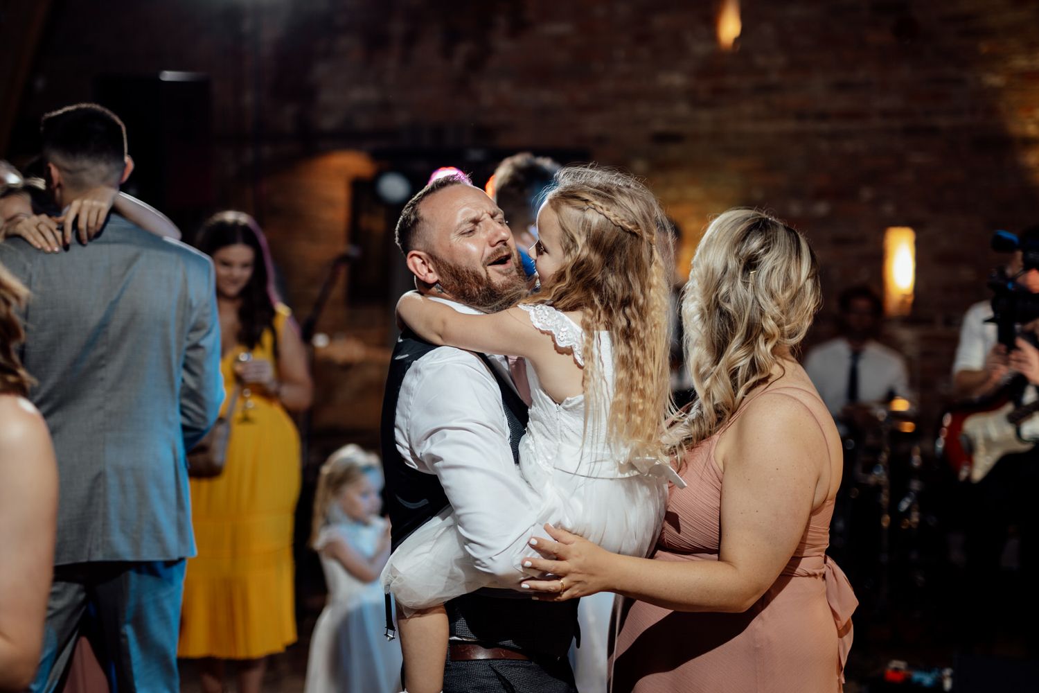 Wedding reception dance floor filled with joyful celebration and ambient lighting.