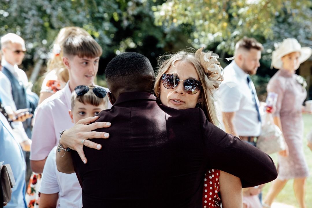 Wedding guests celebrate during an outdoor summer ceremony.