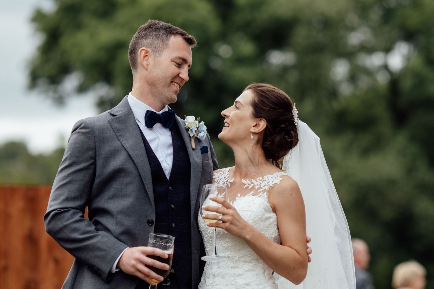 Couple shares laughter during their outdoor wedding photoshoot.