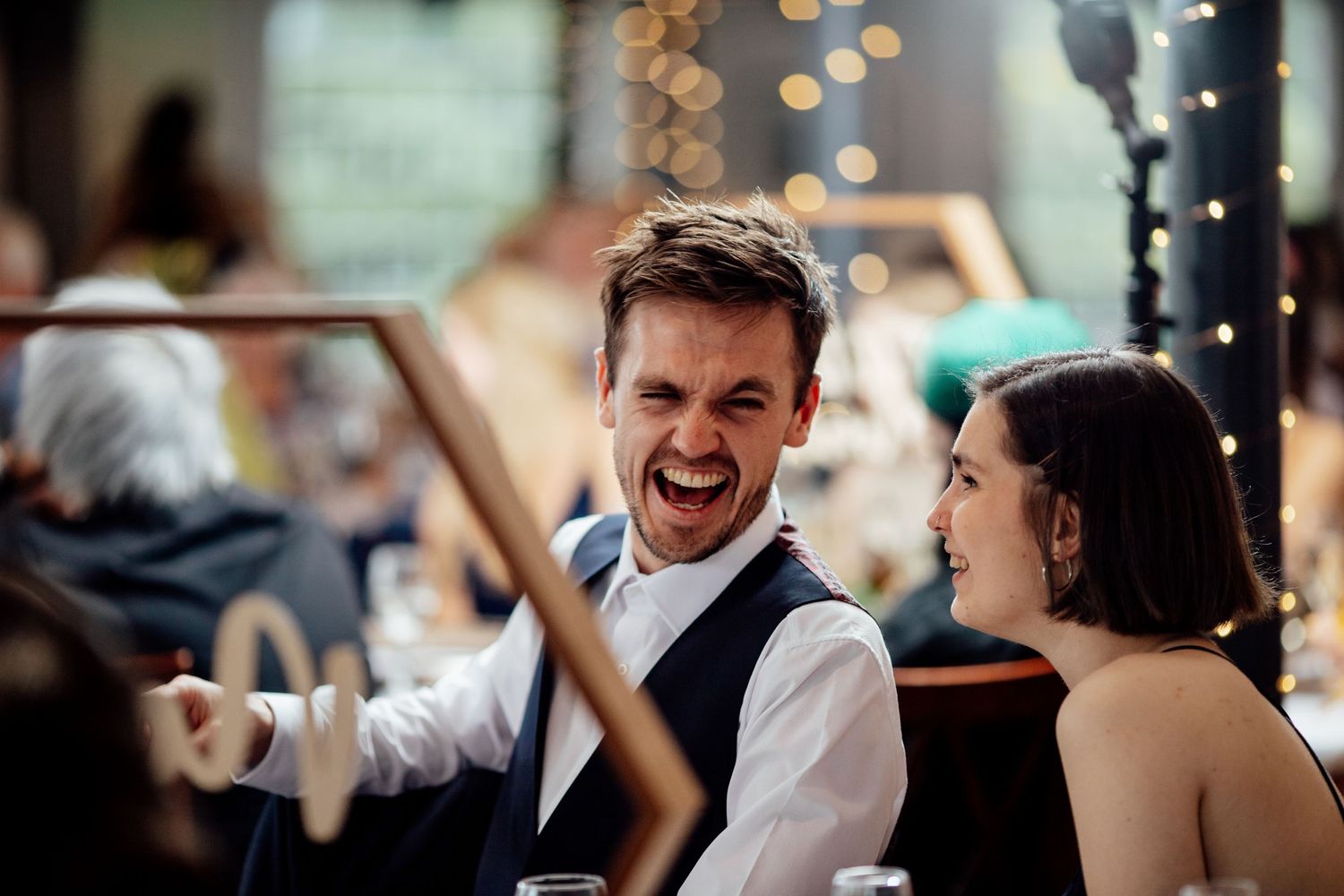 Reception venue with twinkling lights and festive atmosphere during evening celebrations.