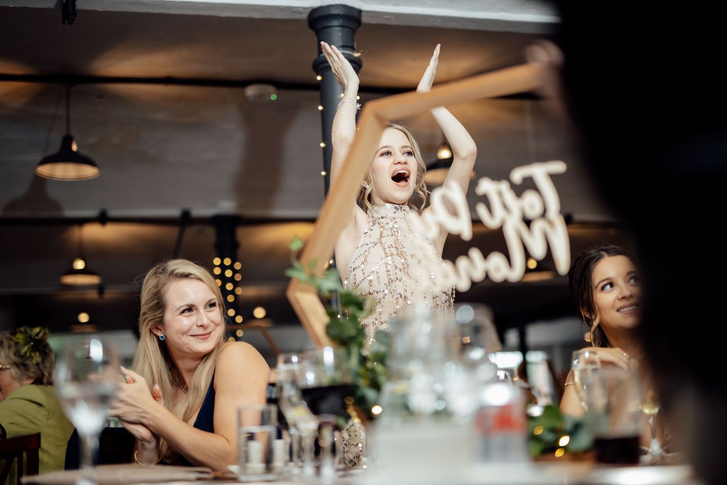 Candid reception moments captured during wedding dinner celebrations.