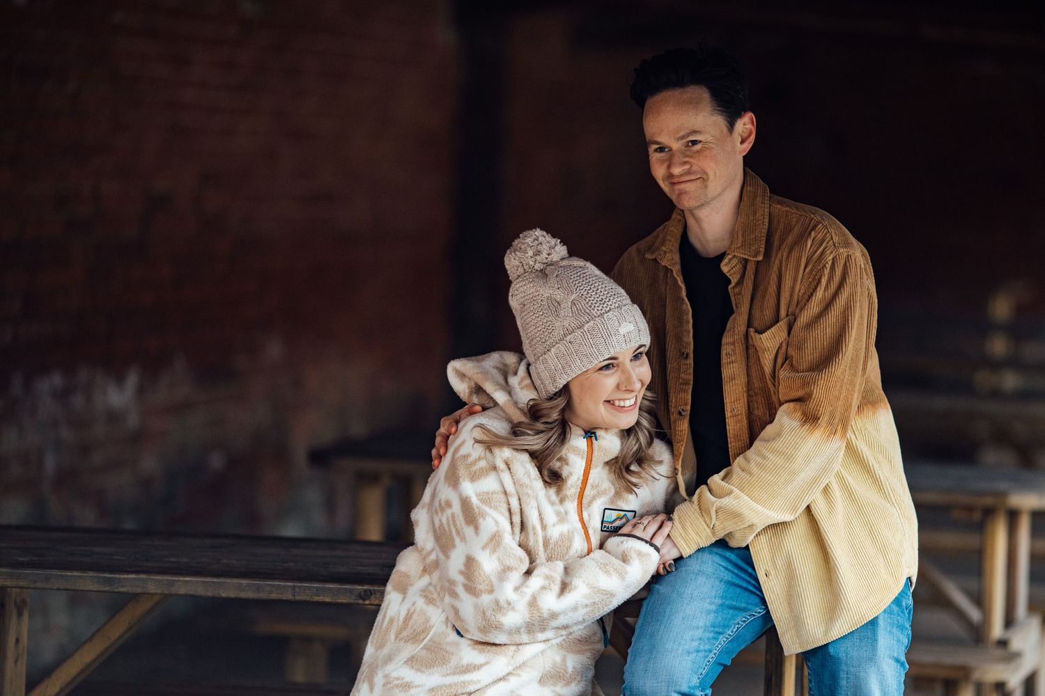 Cozy winter engagement photos captured in warm natural lighting.