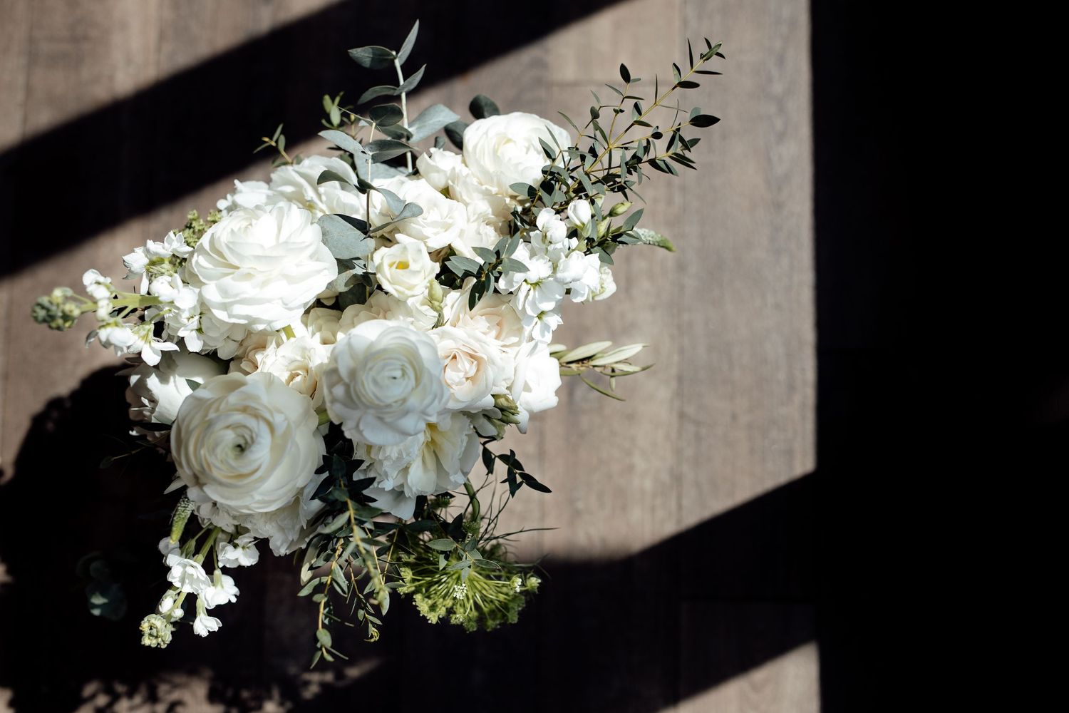 White floral arrangements with roses and greenery create romantic wedding decor.