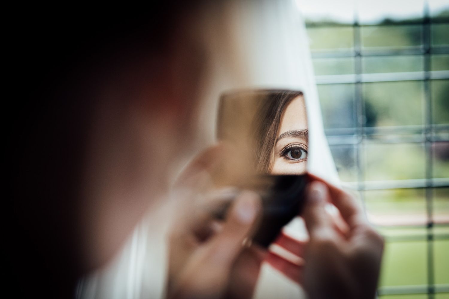 Getting ready scene with soft focus and natural window lighting.