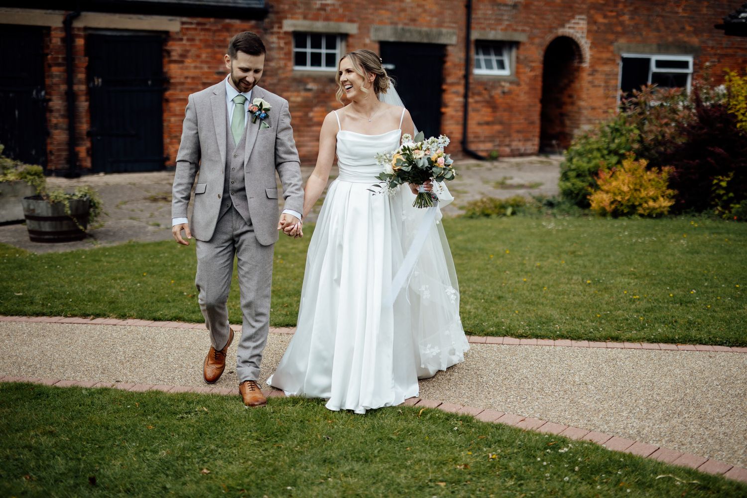 Wedding celebration on grounds of historic brick building venue.