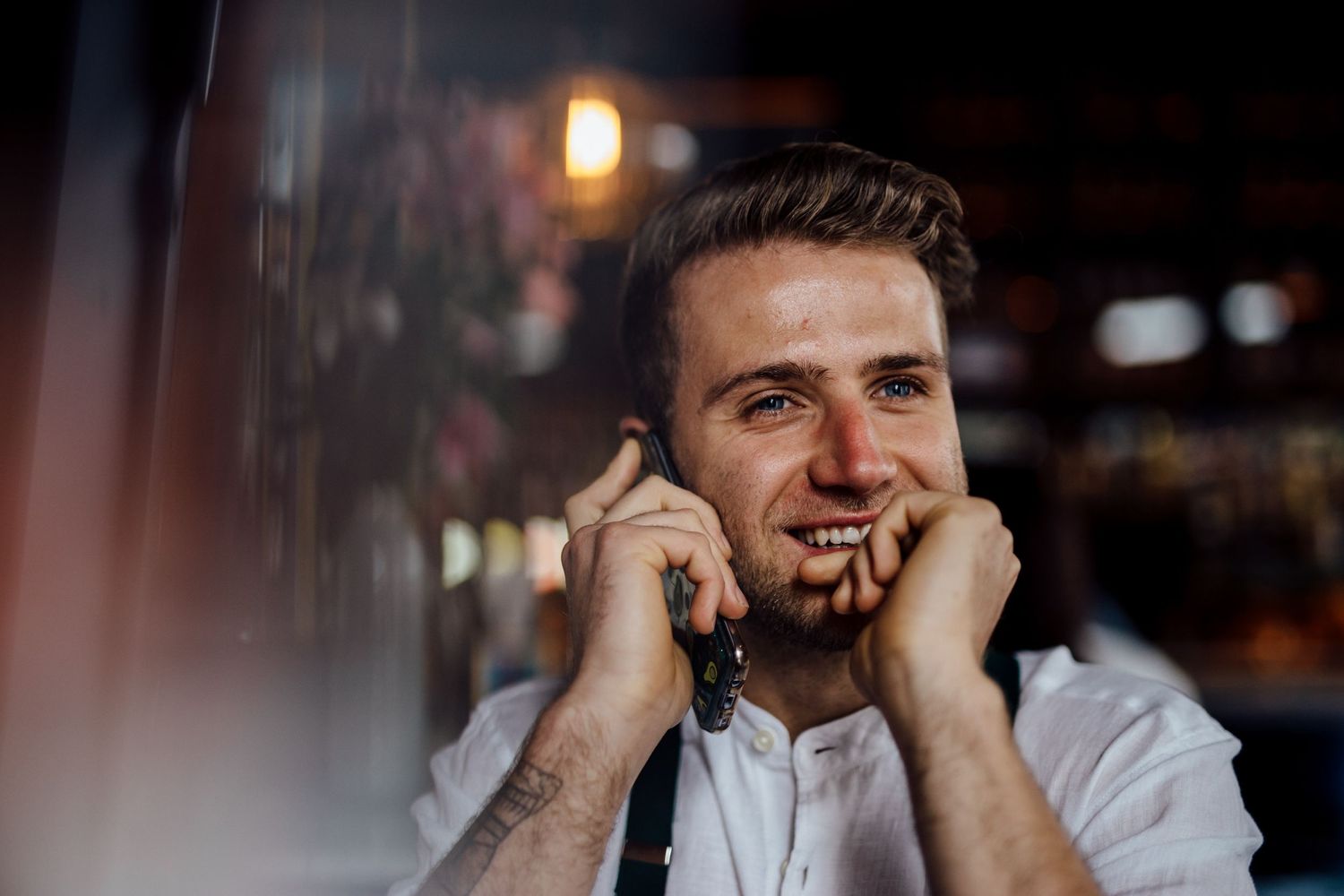 Candid expressions in a dimly lit bar or restaurant setting.