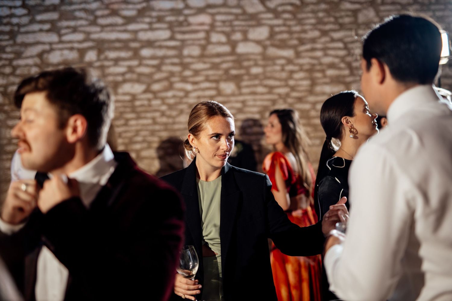 Wedding guests socializing and mingling during an evening reception.