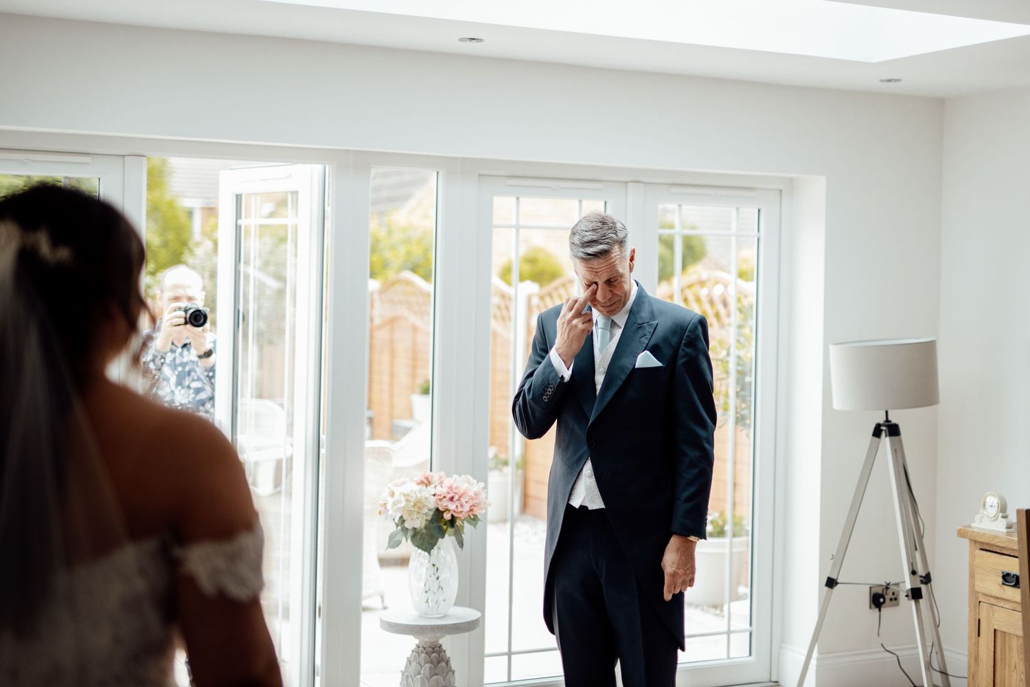 Bright white room with large windows and natural daylight streaming in.