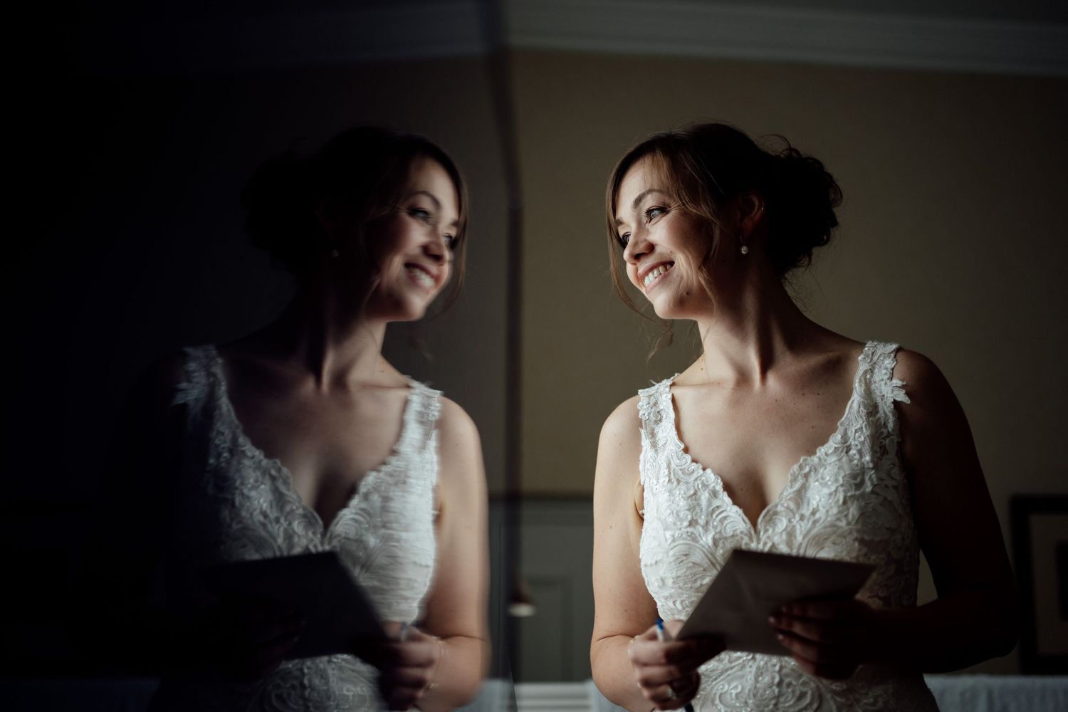 Elegant bridal preparations in a dimly lit room with lace details.