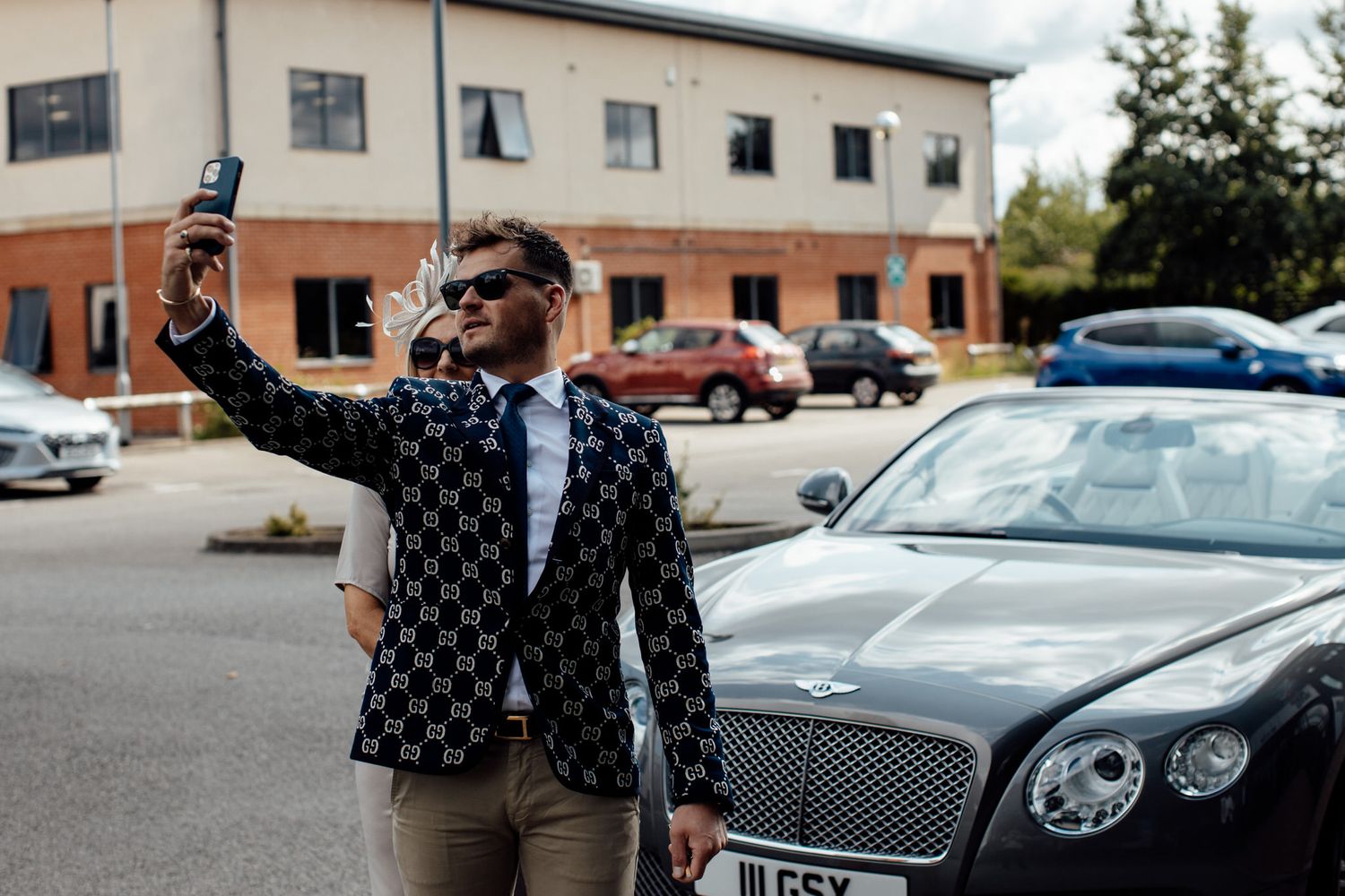 Luxury cars parked outside a modern building for an elegant event.
