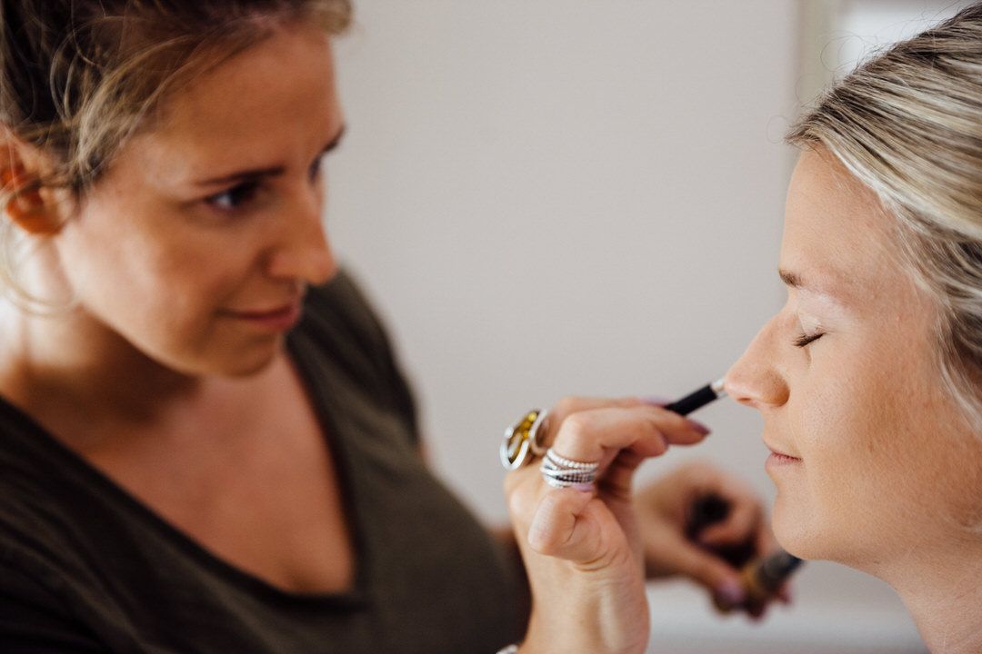 Close-up shots of wedding makeup application with soft natural lighting.