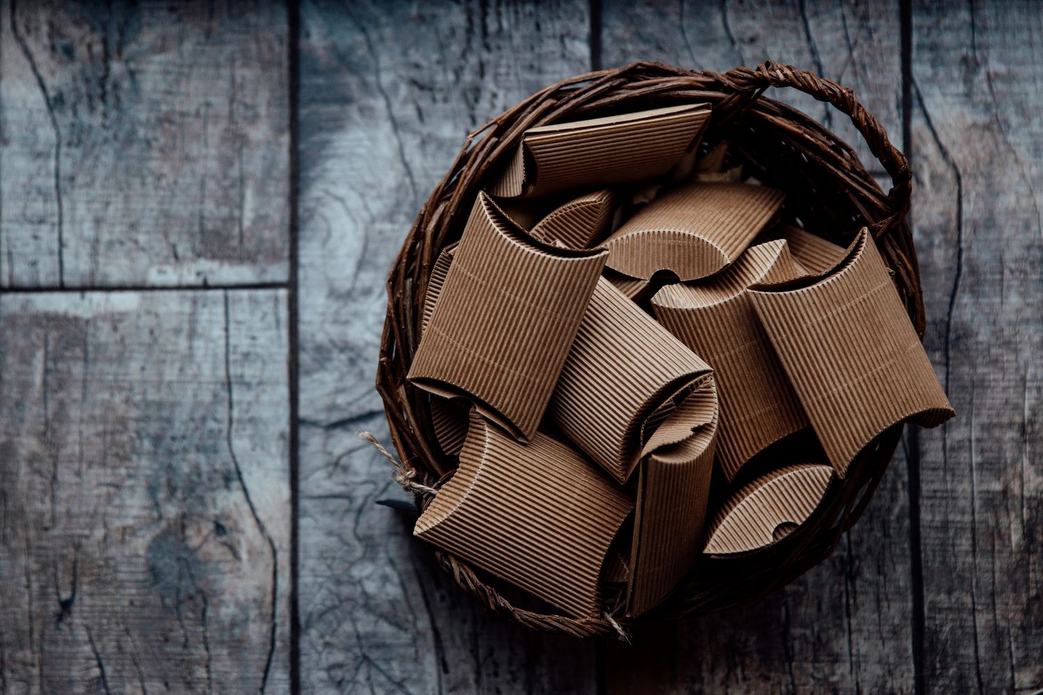 Artistic detail shot of brown ribbons arranged on dark wooden surface.