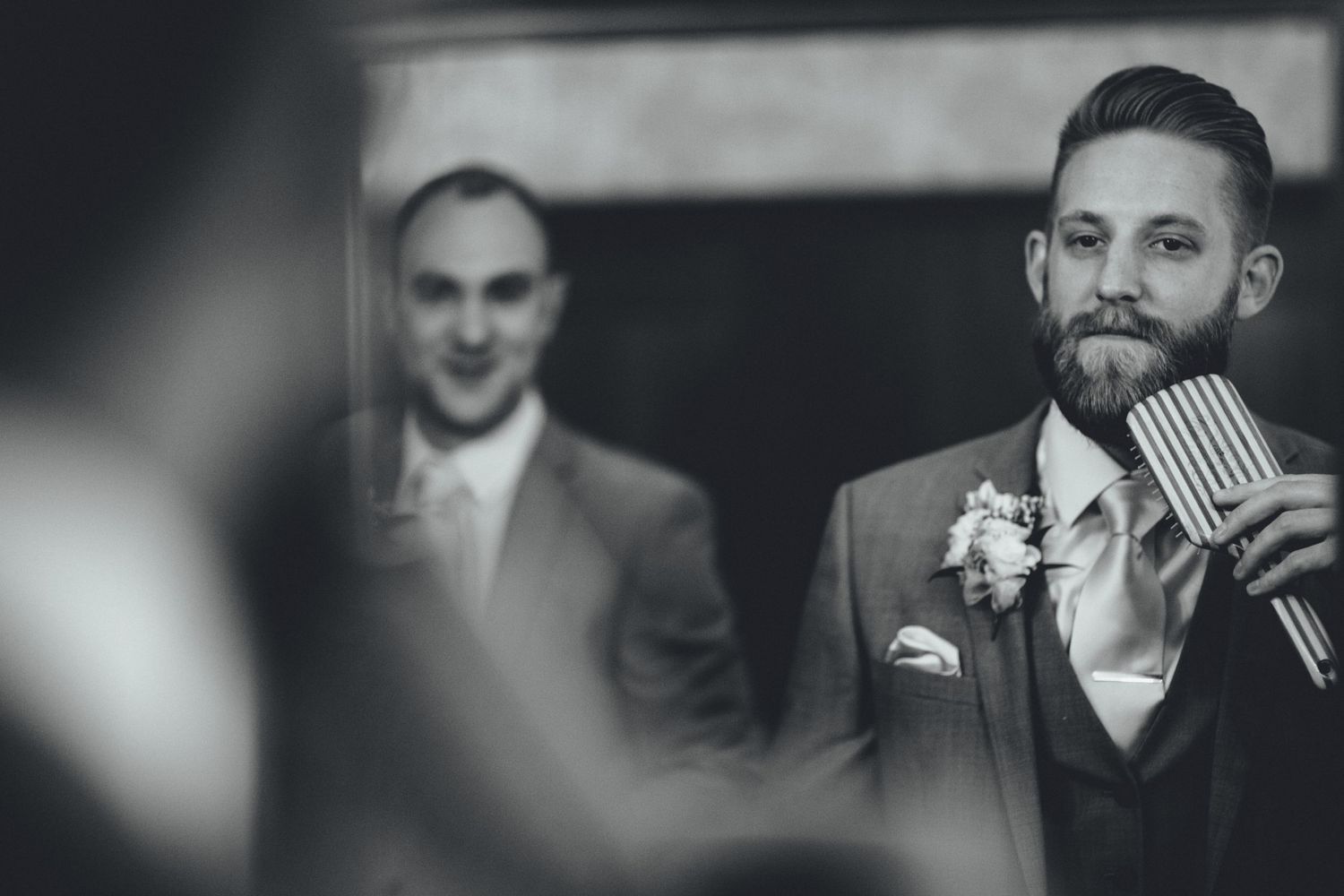 Wedding party members in formal attire shown in dramatic black and white photography.