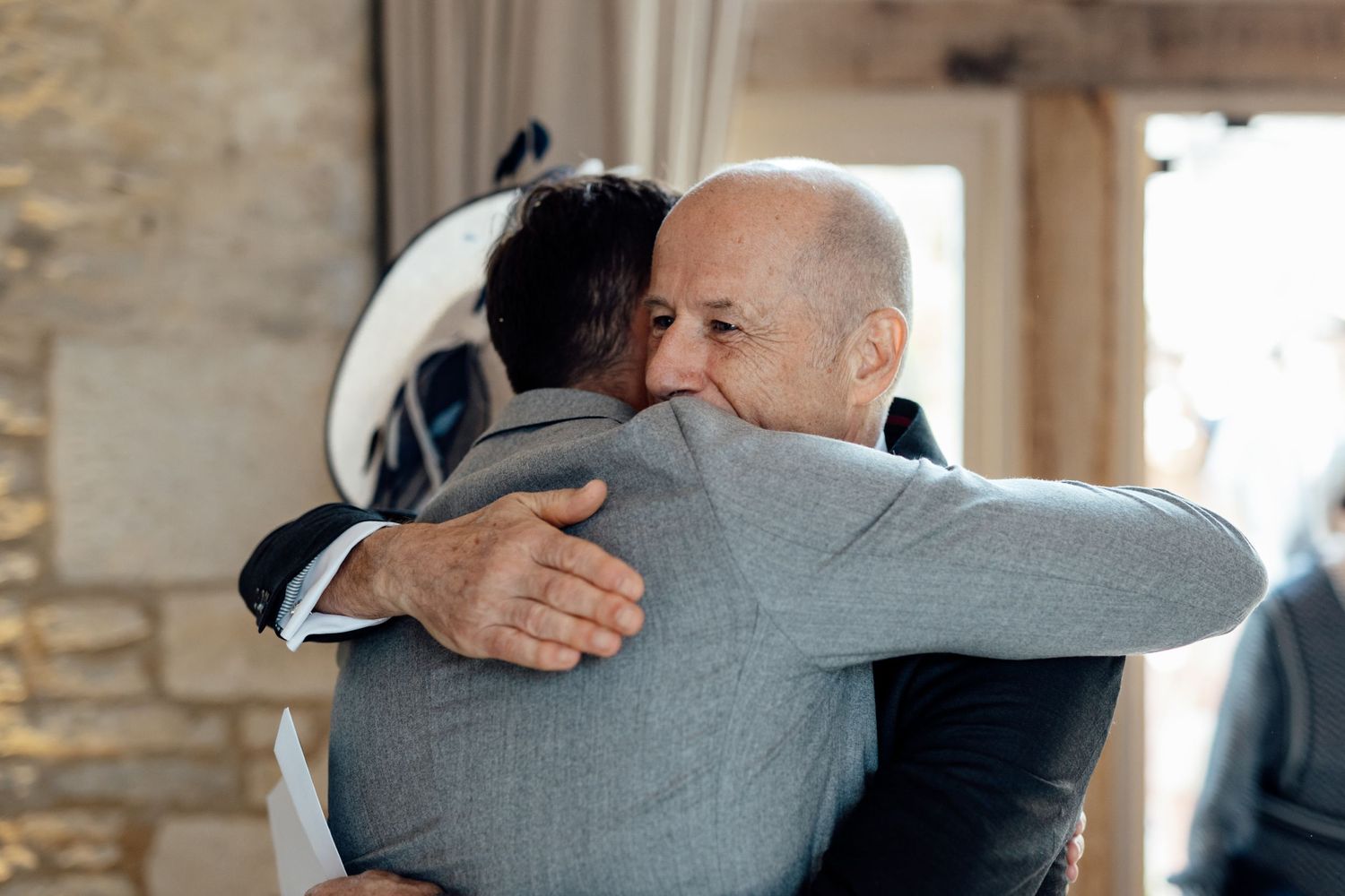 Two people sharing an emotional embrace during a wedding celebration.
