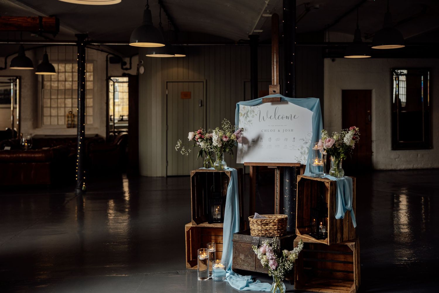 Dark industrial venue space with decorative elements and ambient lighting.