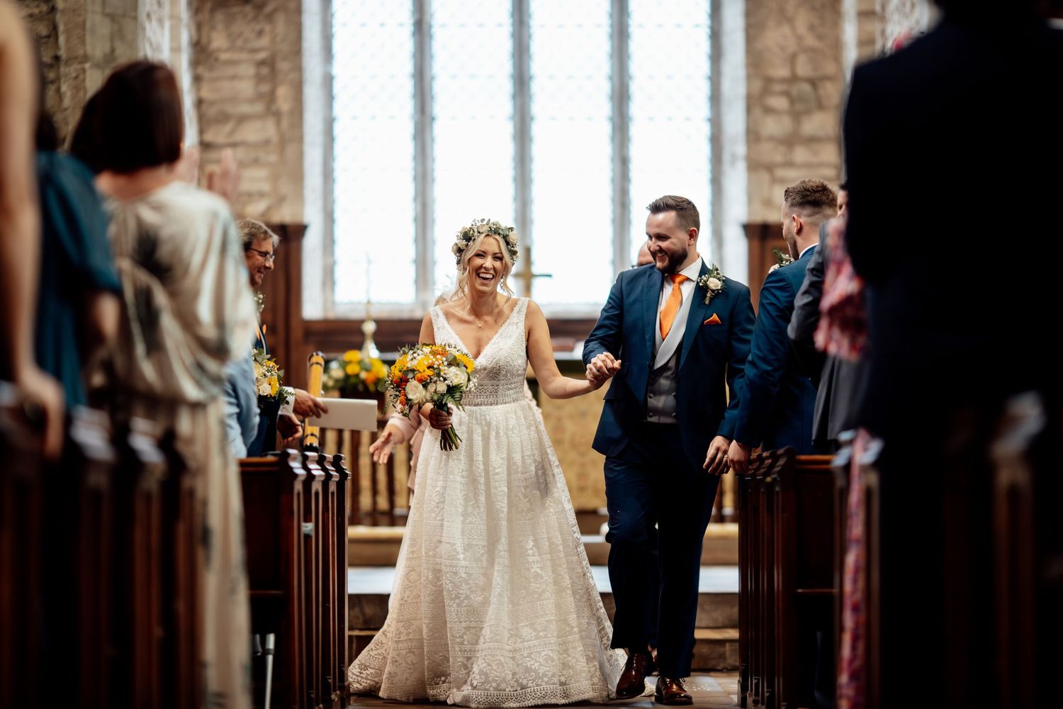 Wedding ceremony in traditional church setting with elegant decor and natural lighting.