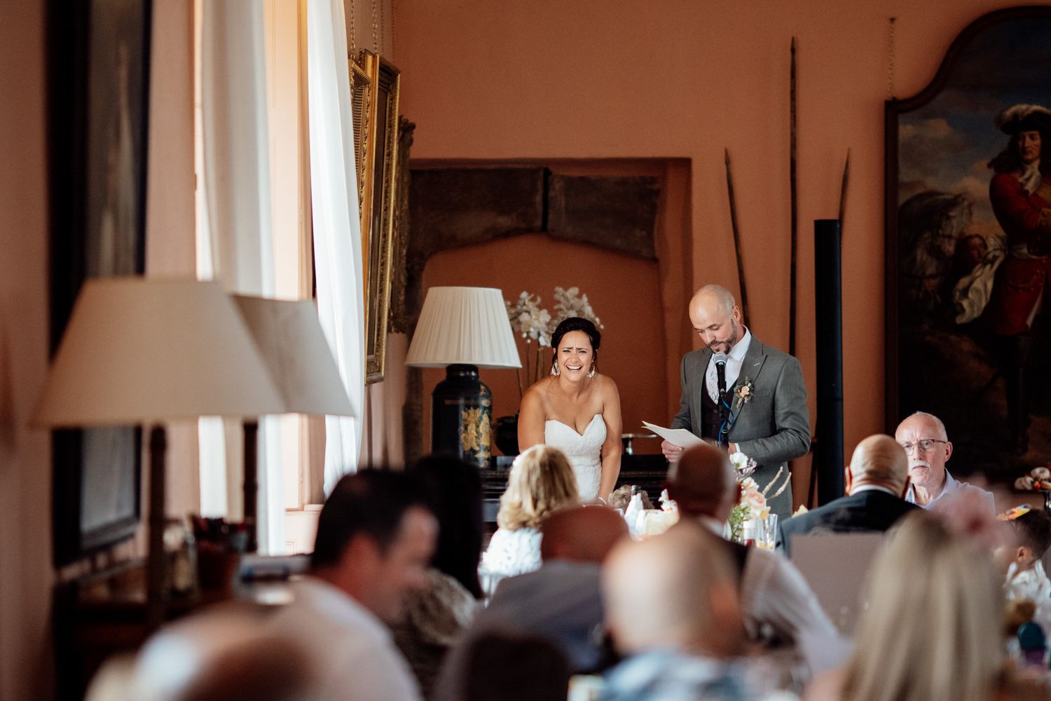 Interior view of an elegant wedding reception venue with warm lighting and classic decor.