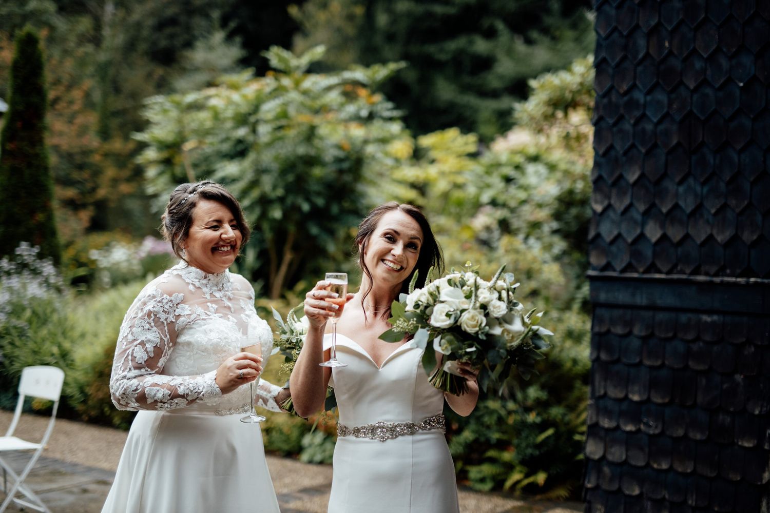 A couple sharing intimate moments and laughter in a lush garden setting.