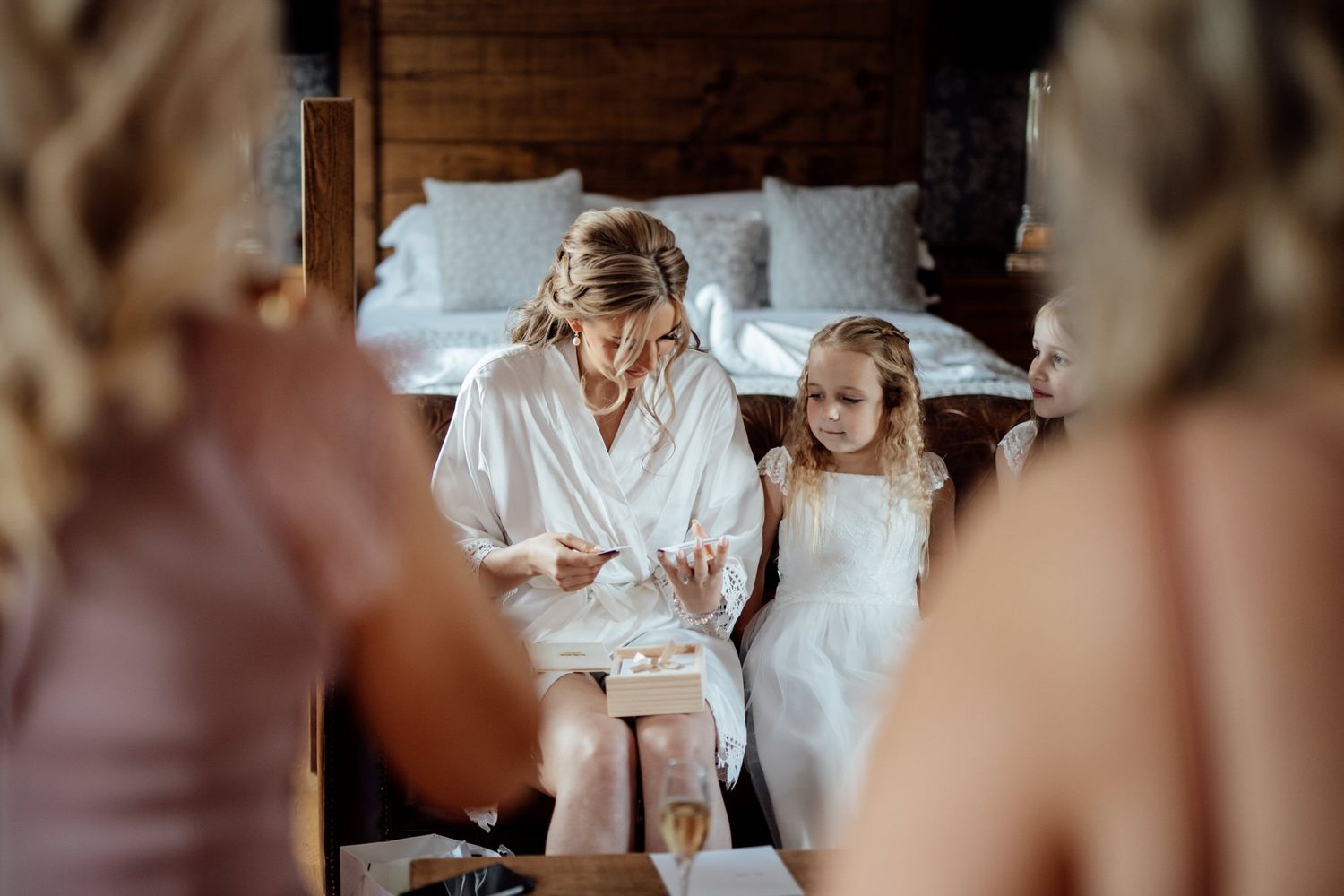 Wedding preparation scene in a rustic indoor setting with natural light streaming through windows.
