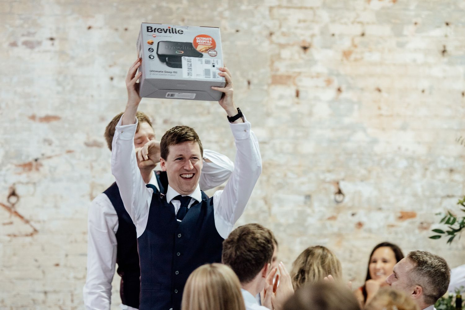Wedding guests celebrating with champagne toasts during reception festivities.