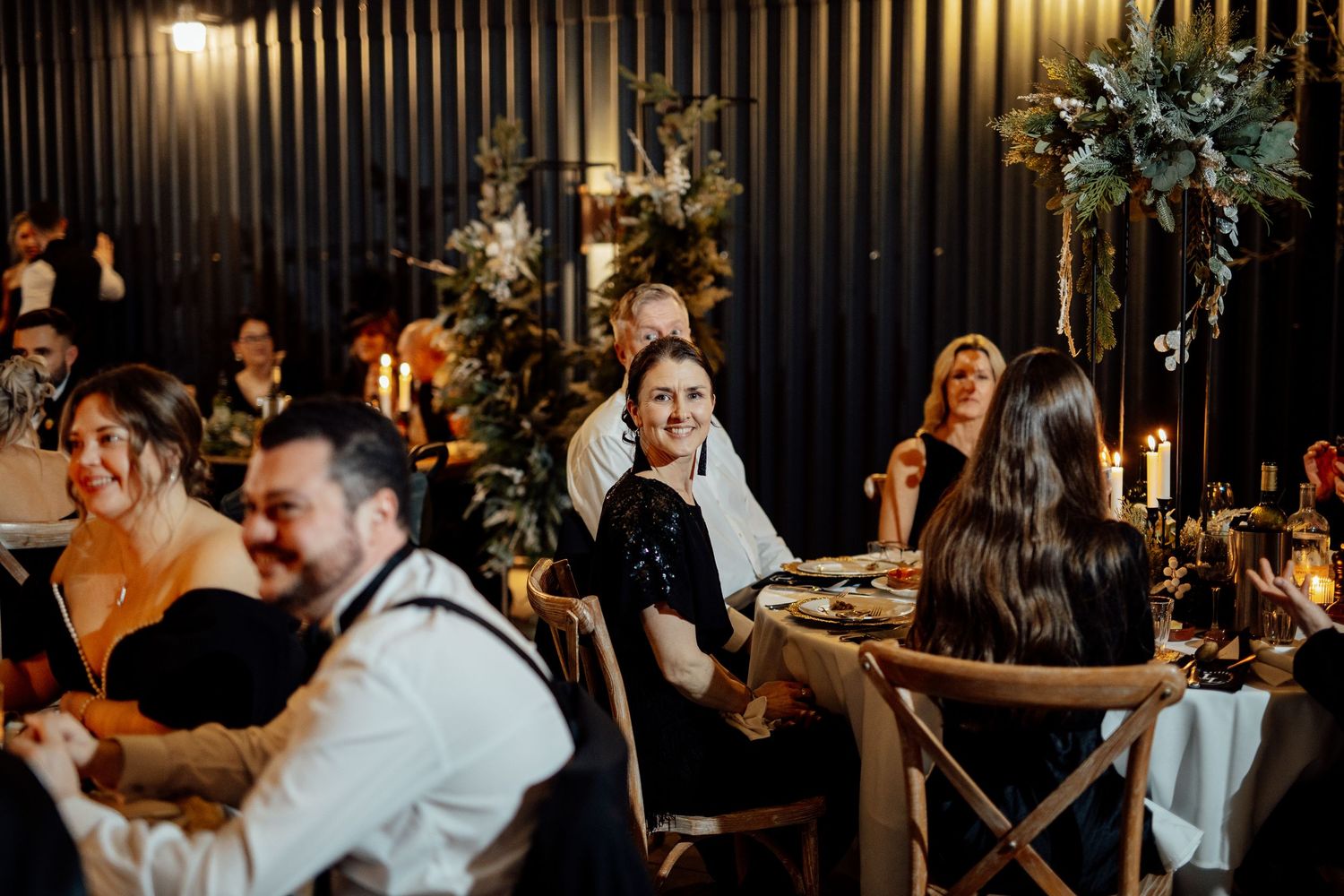 Wedding reception venue with modern industrial decor and ambient lighting.