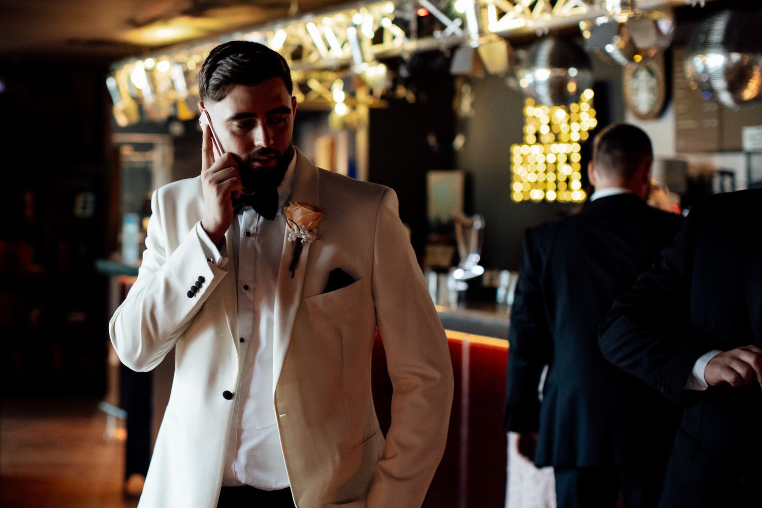Wedding celebration in a dimly lit venue with warm ambient lighting.