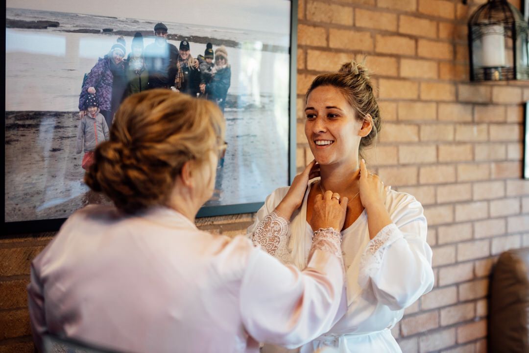 Wedding morning preparations in rustic venue with exposed brick walls.