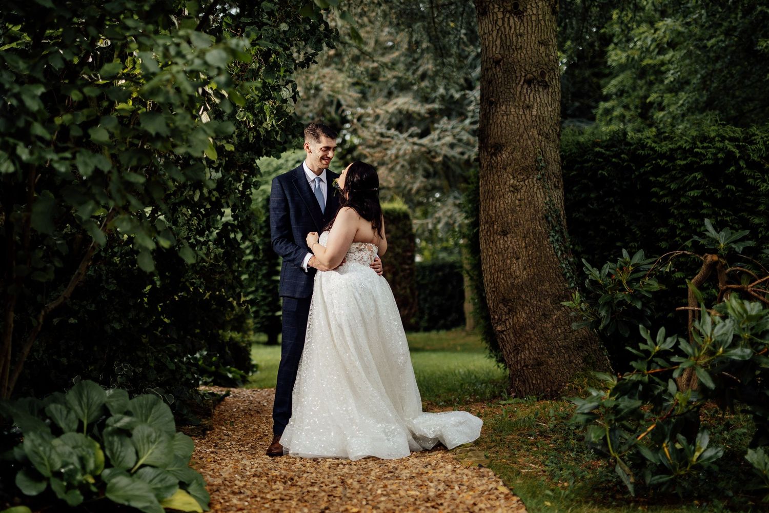 Romantic outdoor wedding portraits captured in a garden setting.
