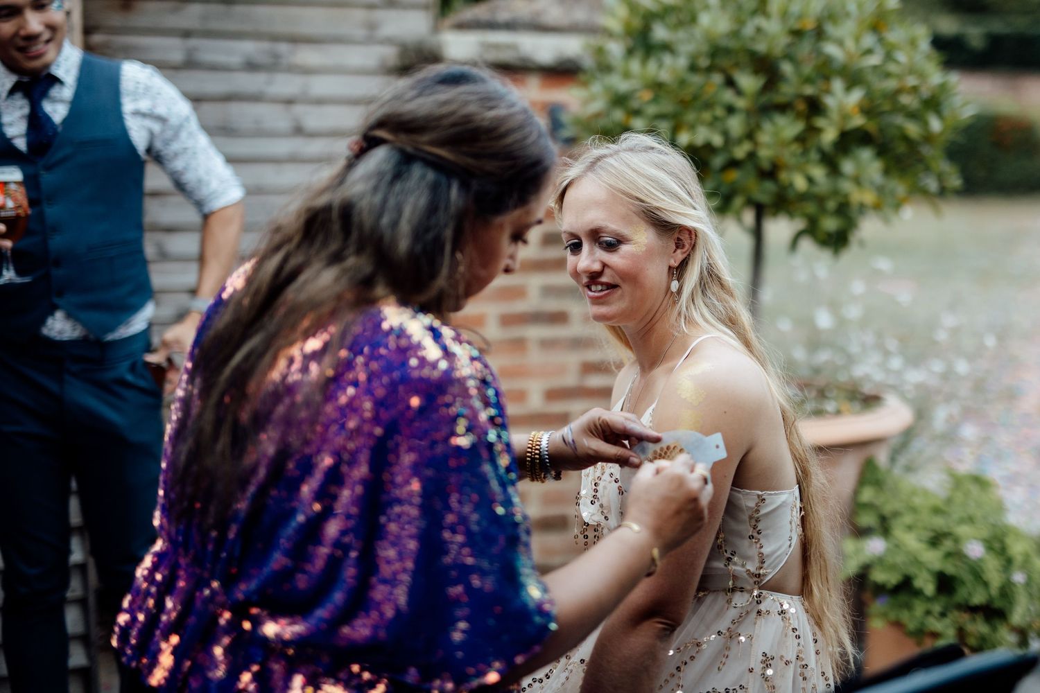 Festive wedding celebration with sparkly decorations in an outdoor garden setting.