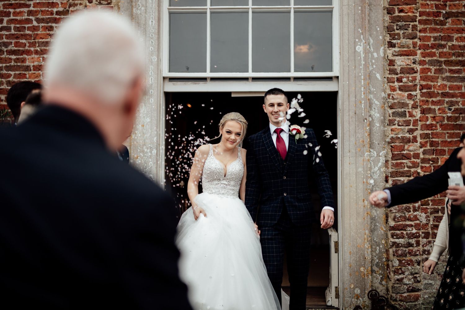 Elegant wedding ceremony in a historic brick venue with classic architectural details.
